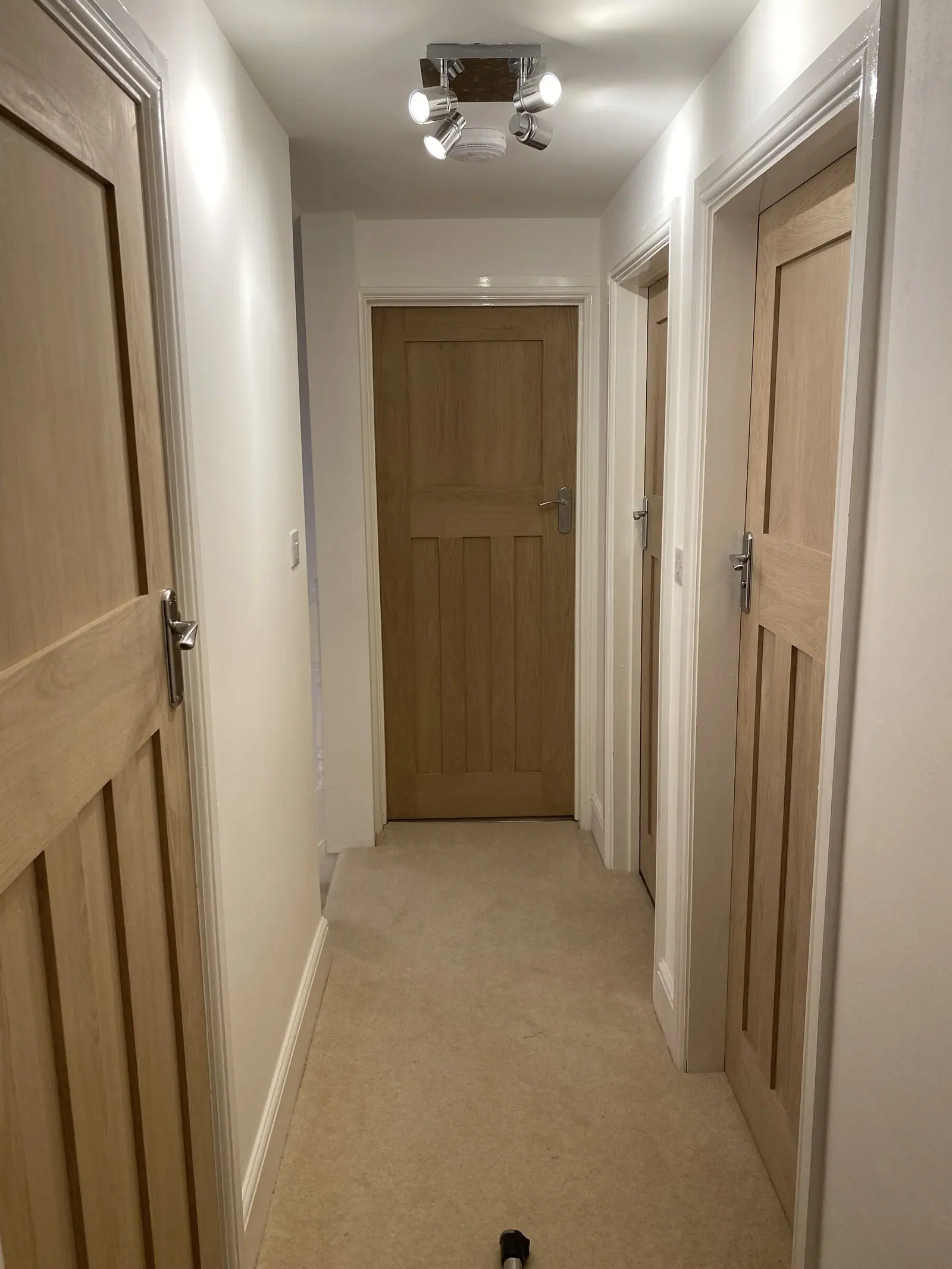 Landing with a full set of oak internal doors, oak-veneered frames and architraves and brushed handles, fitted by Basingstoke Bathrooms